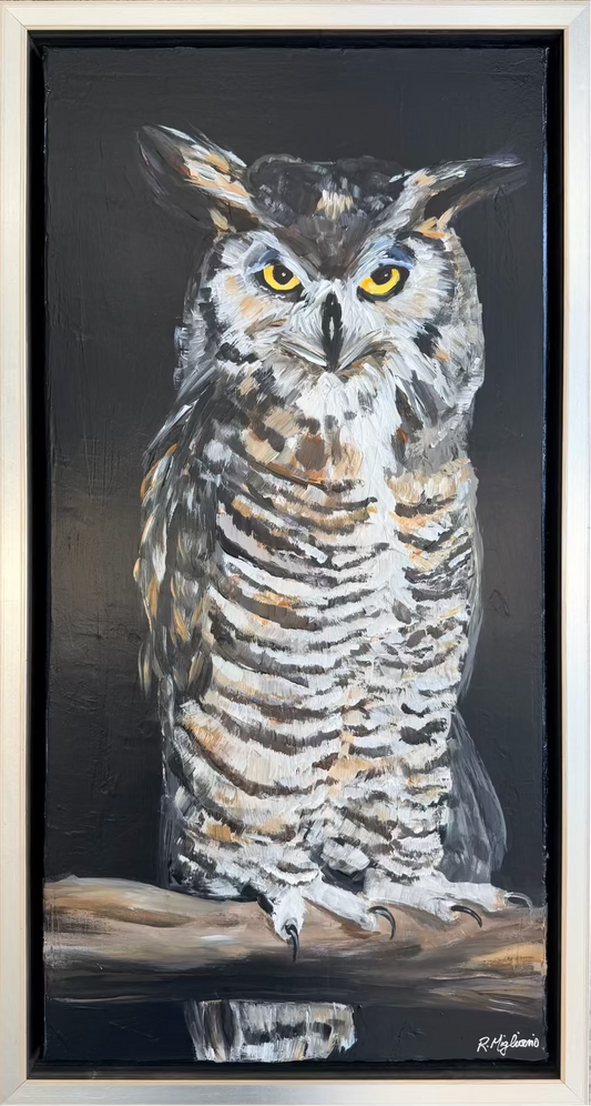 A framed painting of a great horned owl perched on a branch against a dark background, with the owl rendered in white, brown, gray, and black tones with bright yellow eyes.